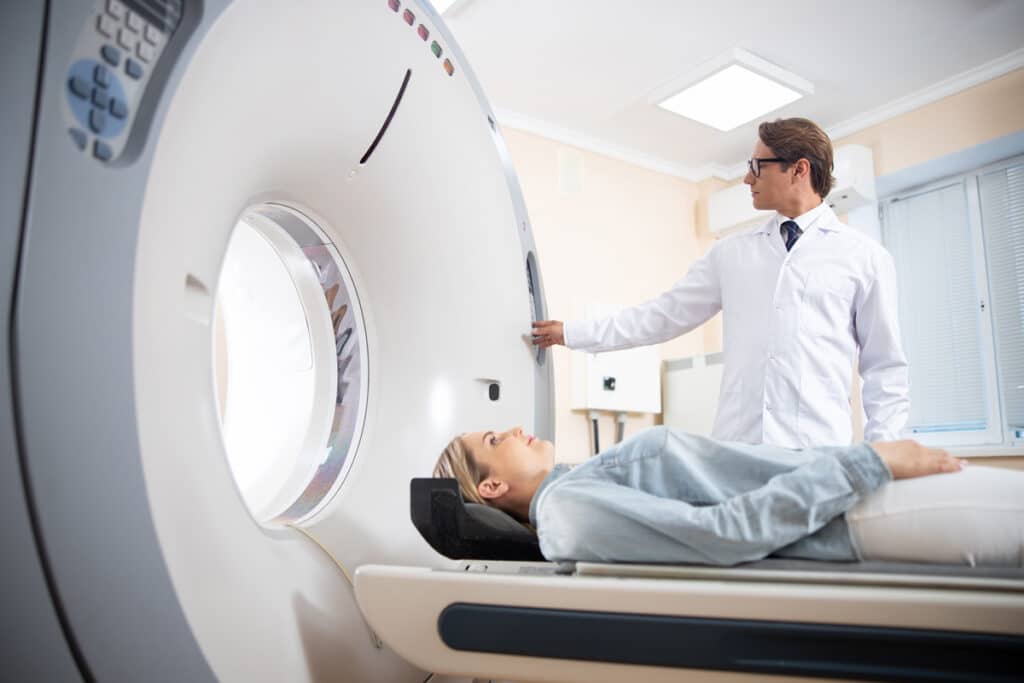 A doctor putting a patient into a CT scan in El Paso.